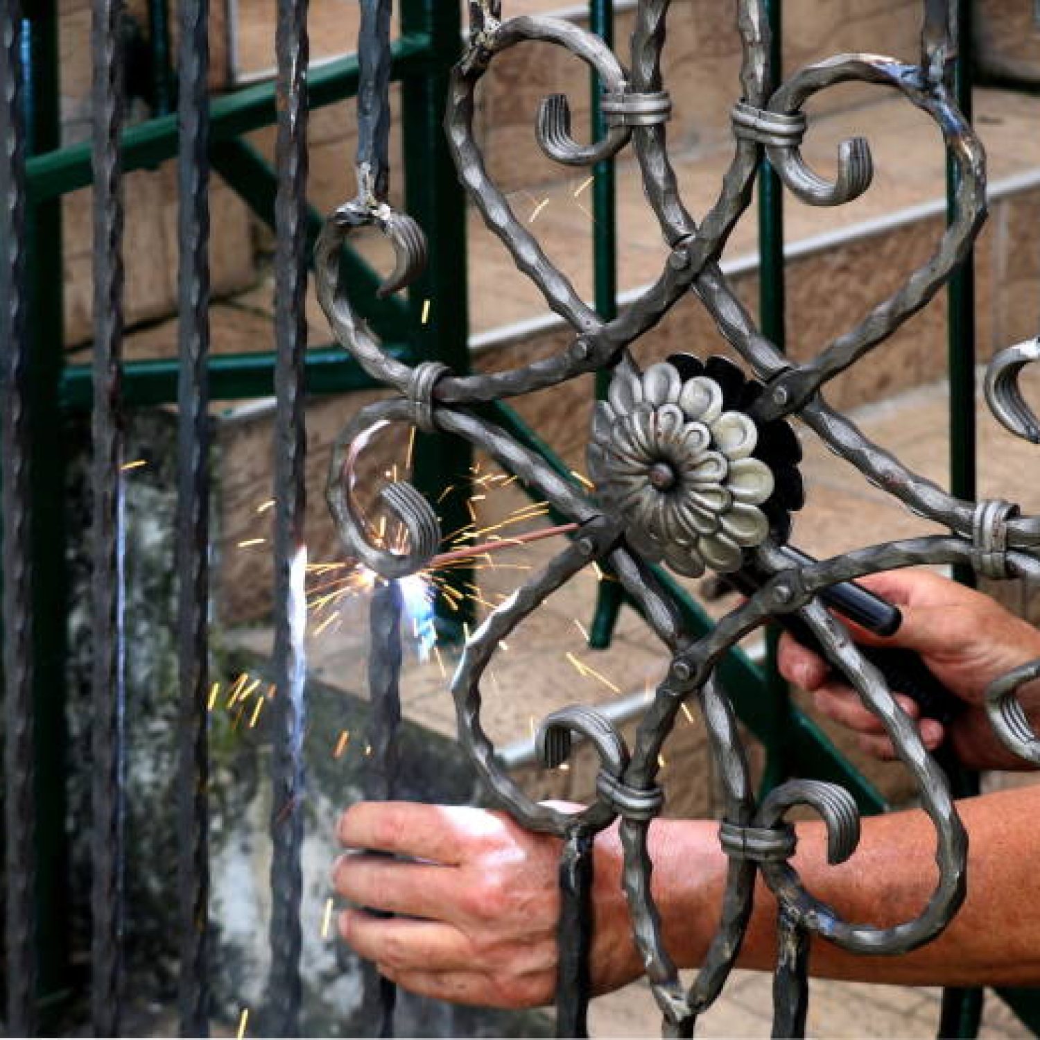 A metal welder at work wearing with sparks flying