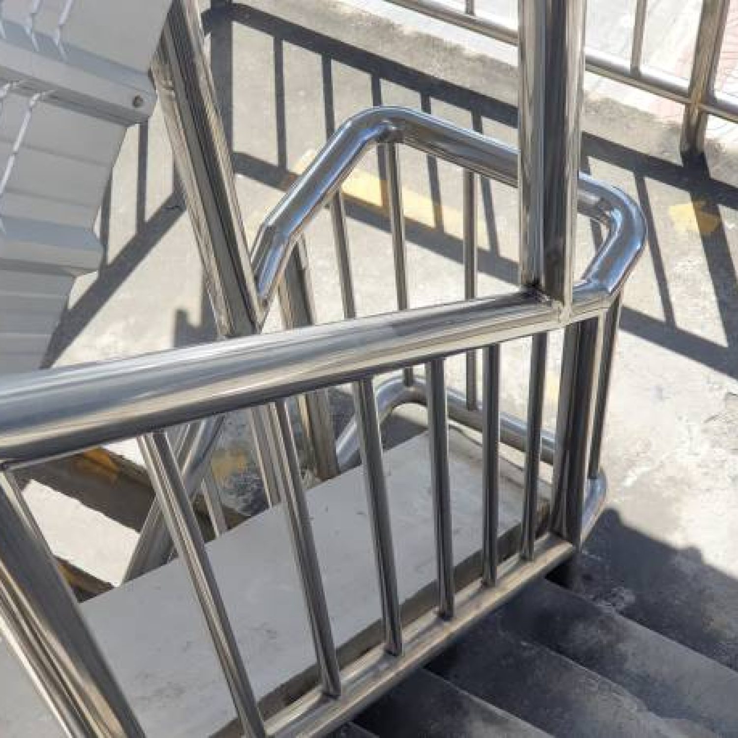 Stainless steel railing.Fall Protection. Railing over pedestrian crossing.